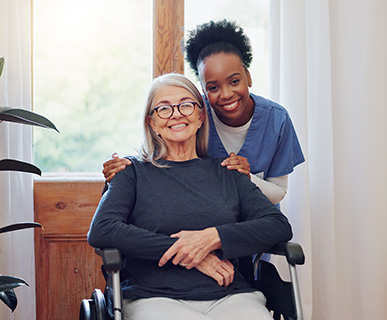 Smiling caregiver helping a senior with daily tasks at home in Reston, VA