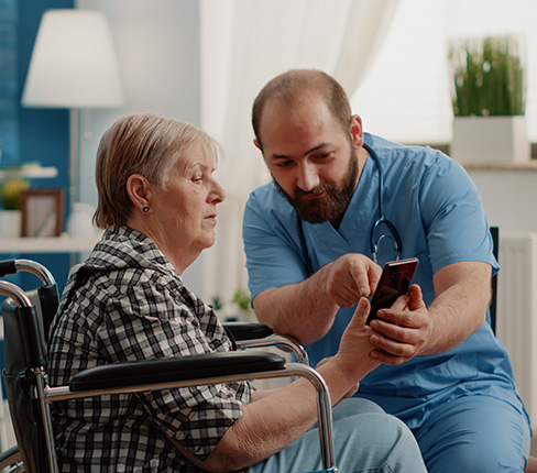 Smiling caregiver helping a senior with daily tasks at home in Reston, VA