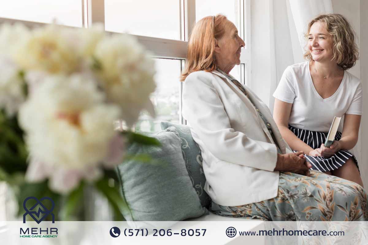 Caregiver helping senior patient with medication at home in Herndon, VA